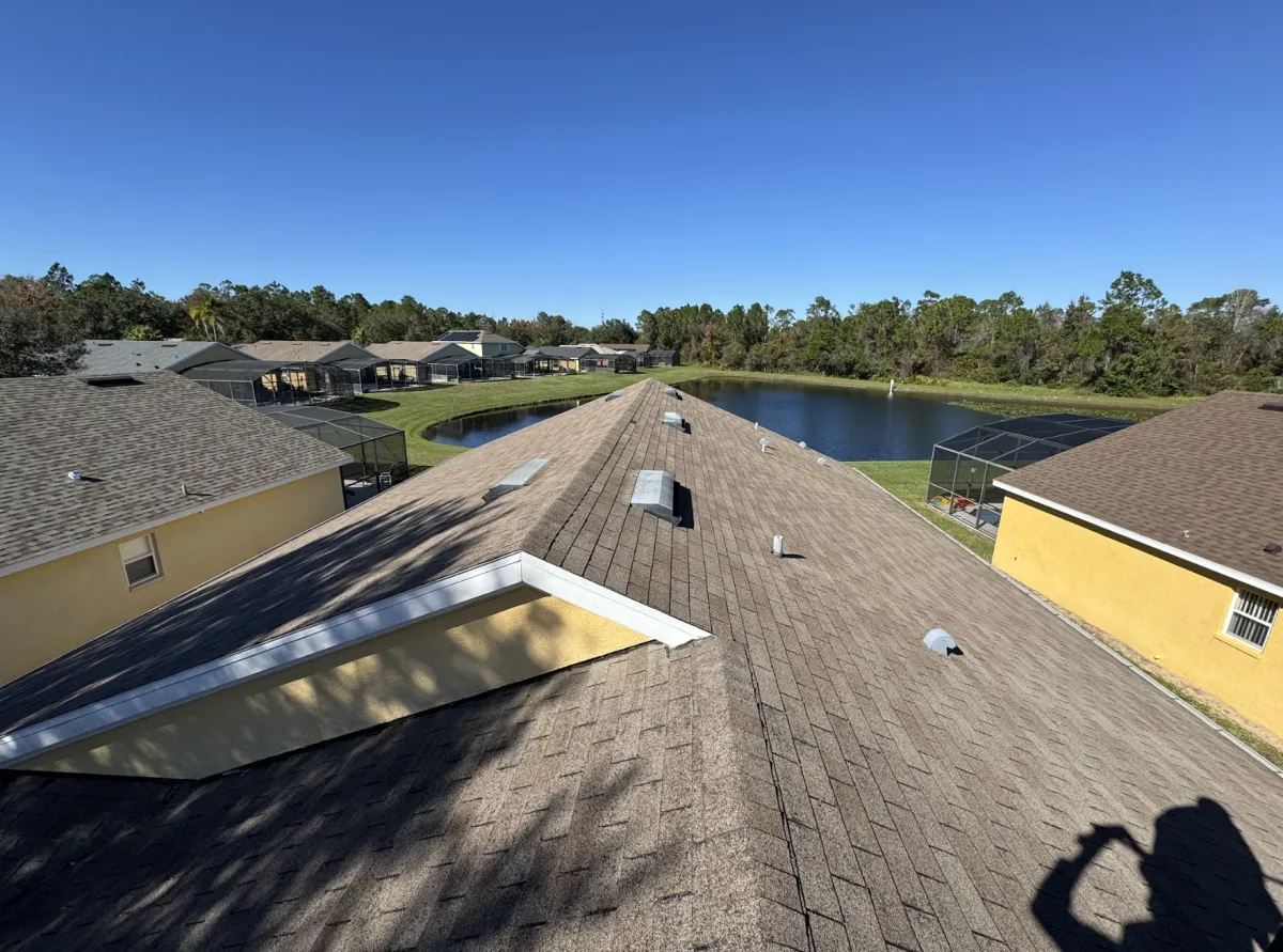 View along a shingle ridgeline between homes overlooking a lake after repairs completed.