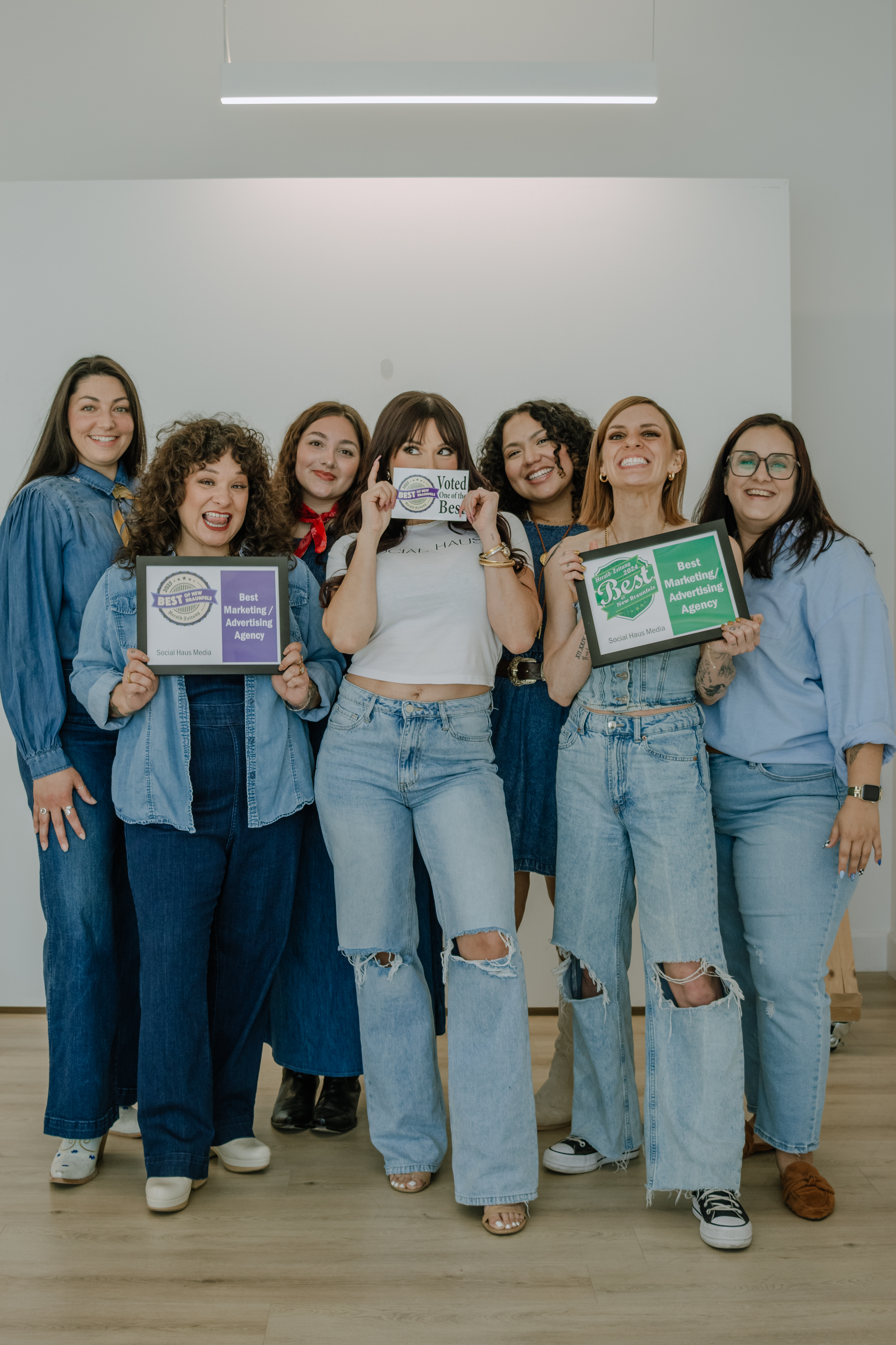 a team of social media marketing girls standing together holding their awards for best marketing agency in new braunfels