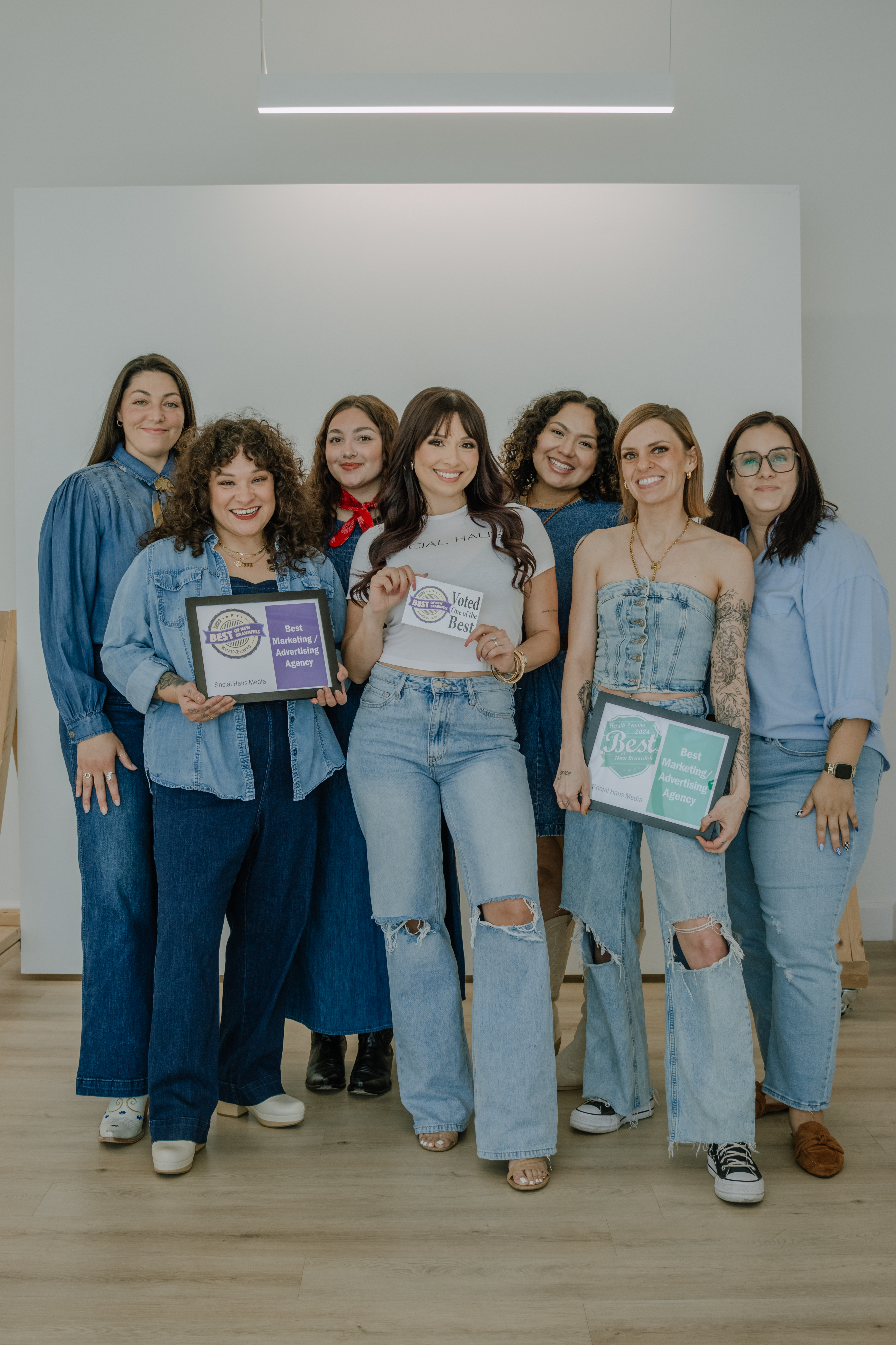 a team of social media marketing girls standing together holding their awards for best marketing agency in new braunfels
