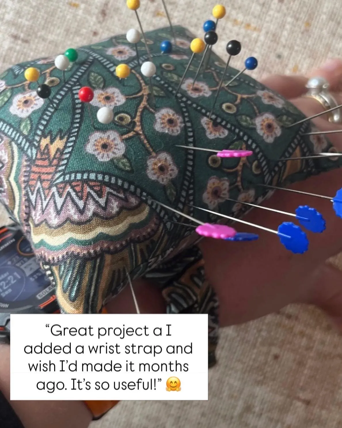 Green patterned pin cushion with elasticated hand strap sewn by Sewing Circle member