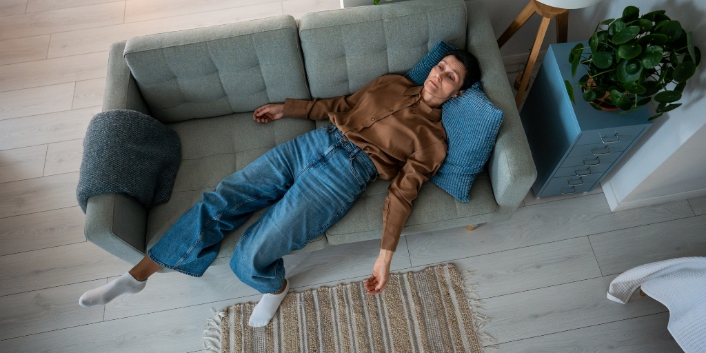 Emotionally overwhelmed woman on the couch at the end of a long day