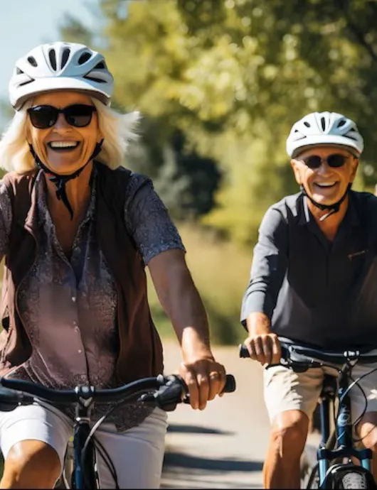 Smiling seniors biking outdoors in Cupertino, seeking herbal medicine support for energy, digestion, pain relief, and natural wellness.
