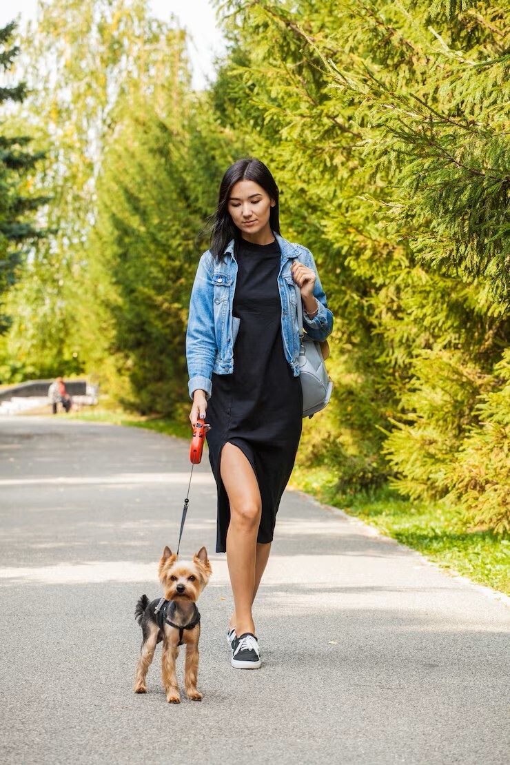young woman happily walking her dog outdoors enjoying life without pain after treatment at a pain control clinic in cupertino ca.