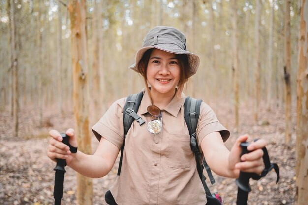 happy woman hiking in the woods, enjoying nature and outdoor activity without chronic pain, thanks to pain control in cupertino ca.