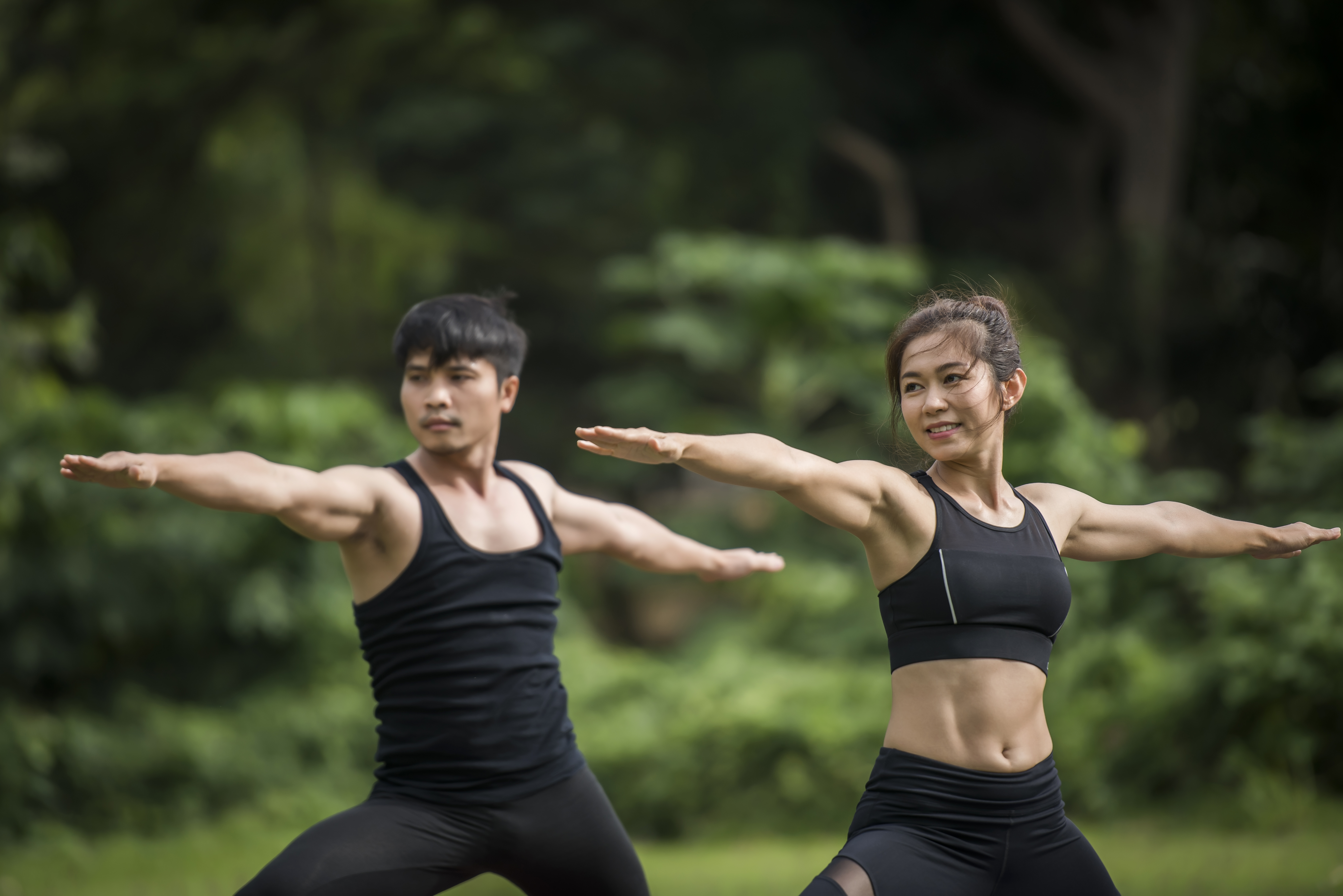it couple performing yoga outside, moving freely and painlessly after receiving treatment at a pain control clinic in cupertino ca.