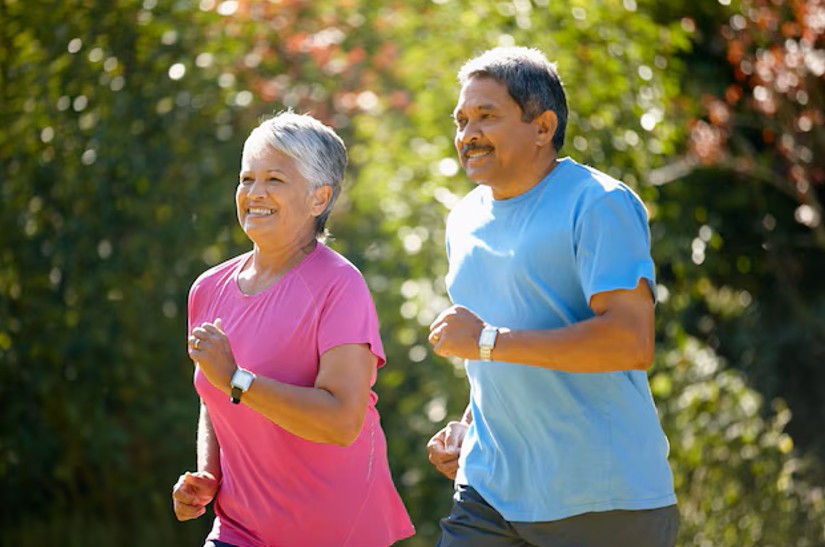 older couple jogging together in a park, enjoying improved mobility and freedom from joint pain after receiving pain control in cupertino ca.