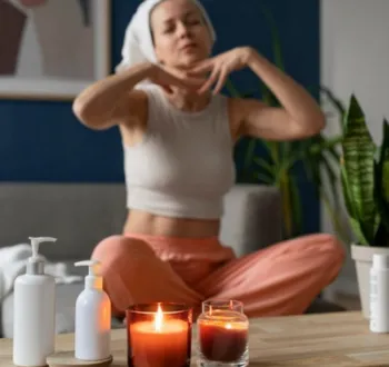 woman performing a neck stretch in a comfortable home setting with scented candles from her holistic acupuncture clinic care in cupertino ca.