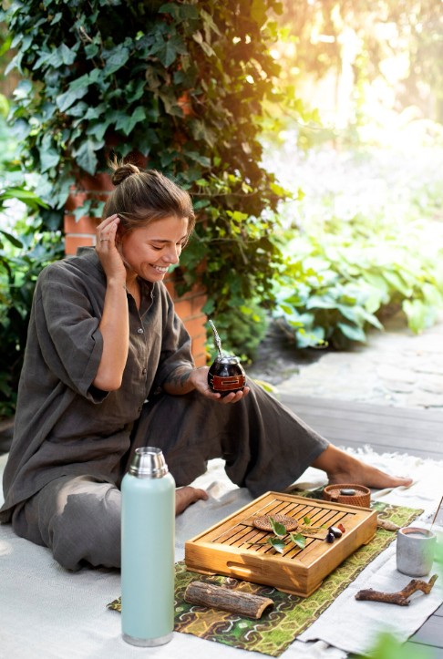 smiling woman enjoying yerba mate outside, feeling well after visit to alternative medicine practitioner in cupertino ca.