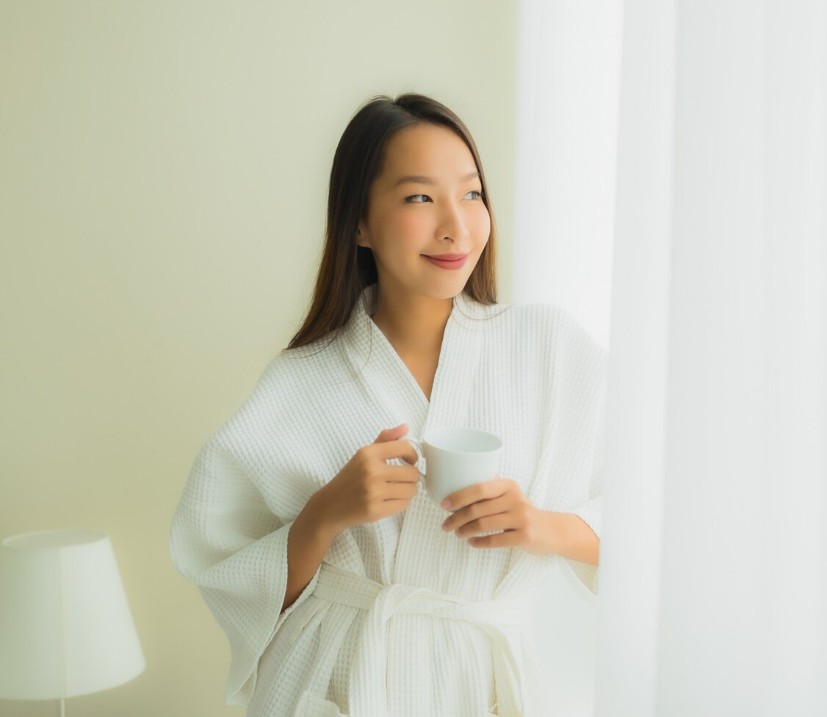 woman in robe enjoying morning coffee at home, feeling refreshed after visiting holistic medicine practitioner in cupertino ca.