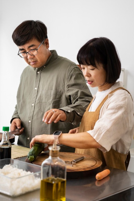 couple preparing food in kitchen, guided by knowledge from a herbal medicine practitioner in cupertino ca.