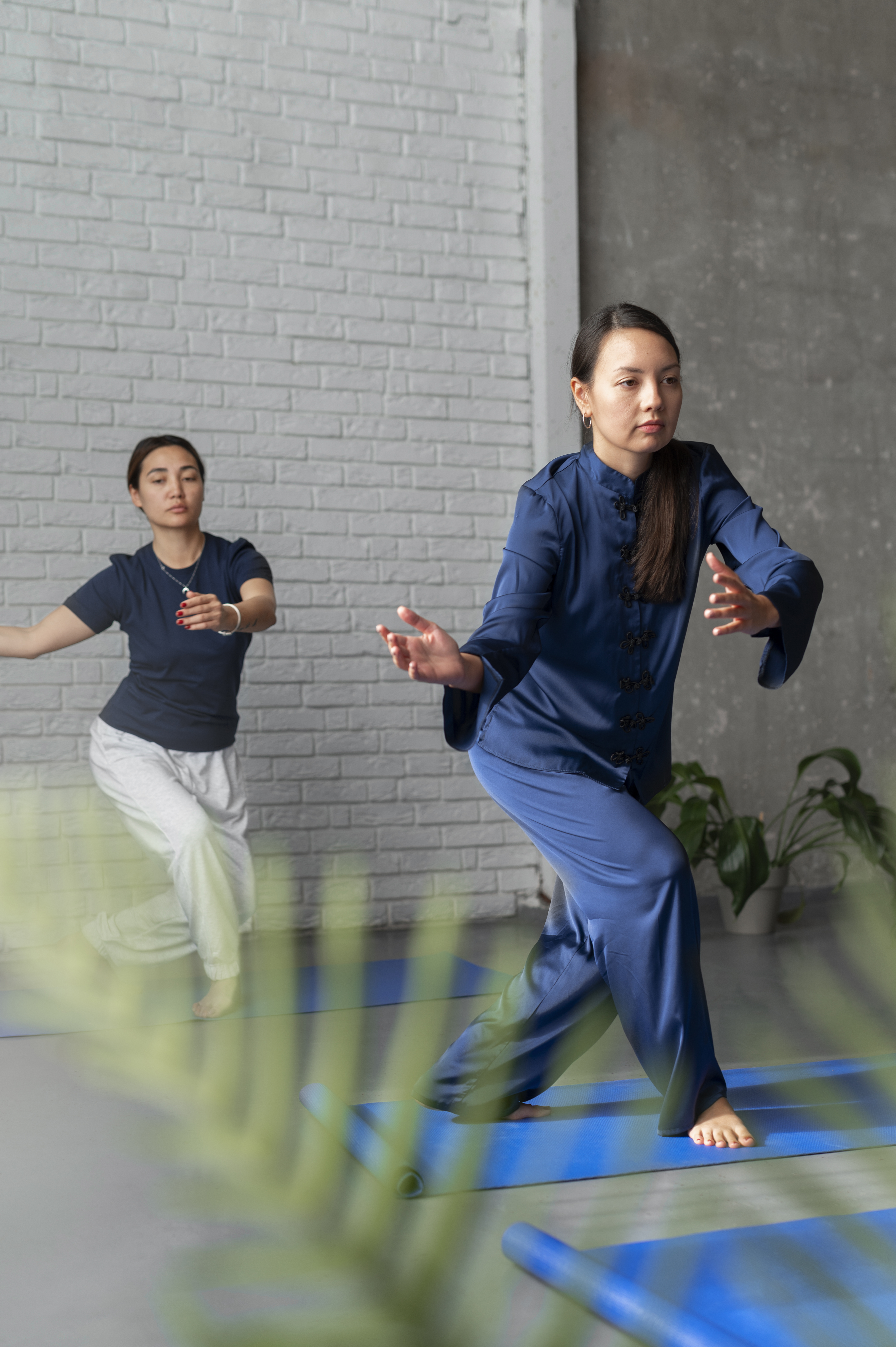 women practicing tai chi in a studio after receiving care at a cupertino ca acupuncture clinic.