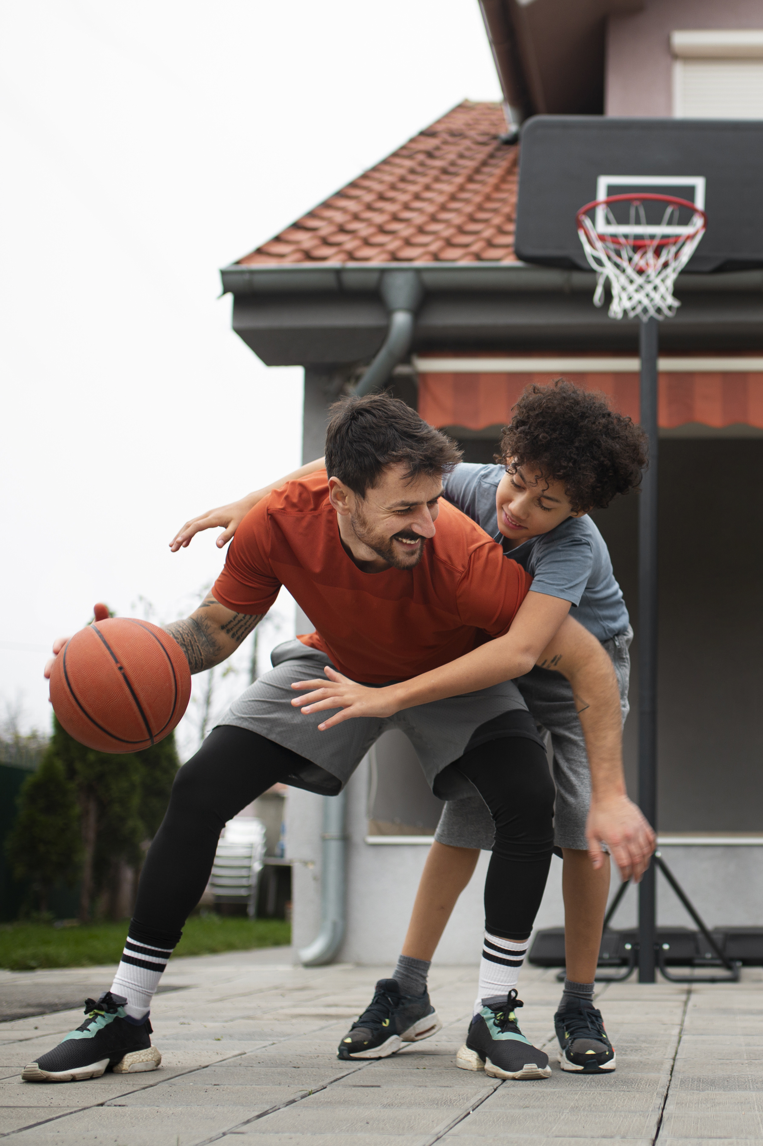 happy father and son playing basketball outside after visiting an acupuncture clinic in cupertino ca.