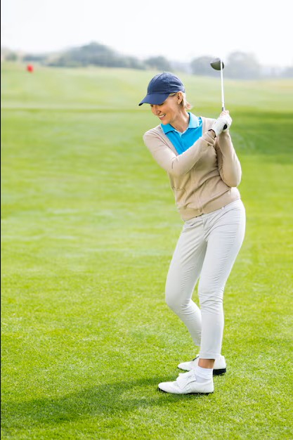 woman smiling while playing golf after successful visits to an acupuncturist depressiontreatment in cupertino ca.