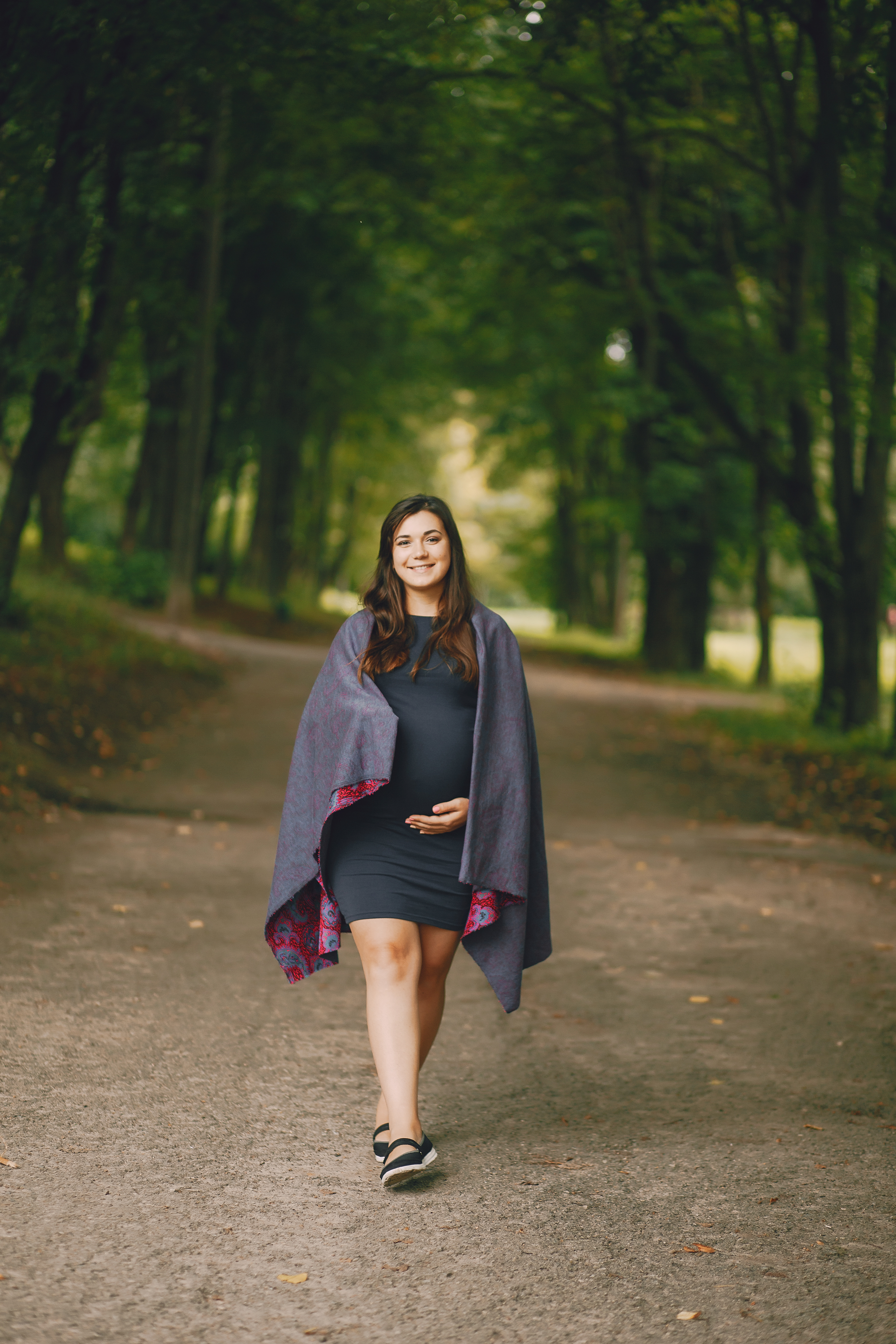 smiling woman walking outdoors thanks to natural pregnancy support in cupertino ca for a healthy journey.