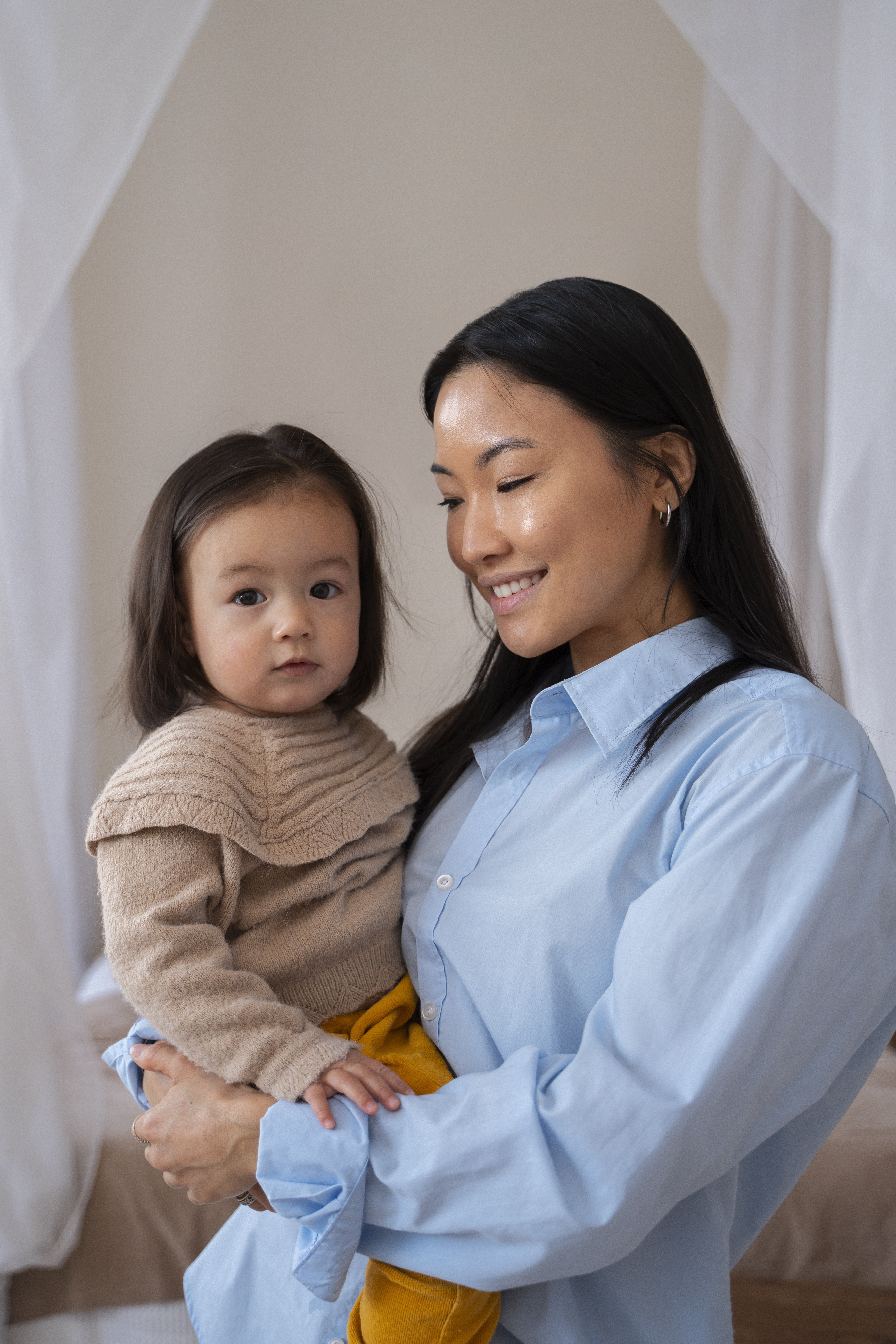 happy woman holding her smiling baby after successful treatment at a fertility acupuncture clinic in cupertino ca.