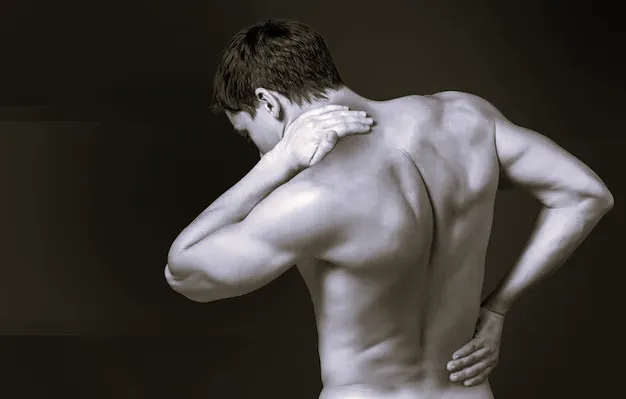 Fit woman with shoulder pain at gym