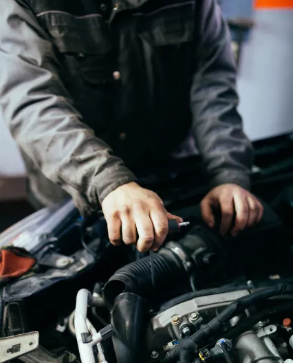 A man polishing a red car