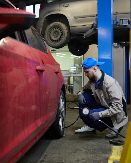 A person wiping the hood of a black car
