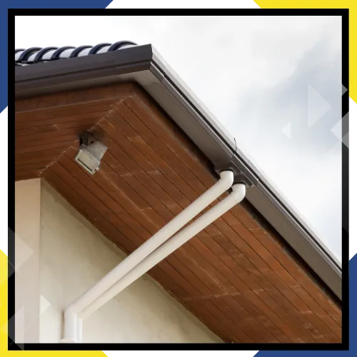 Gutter installers working along a clean roofline 