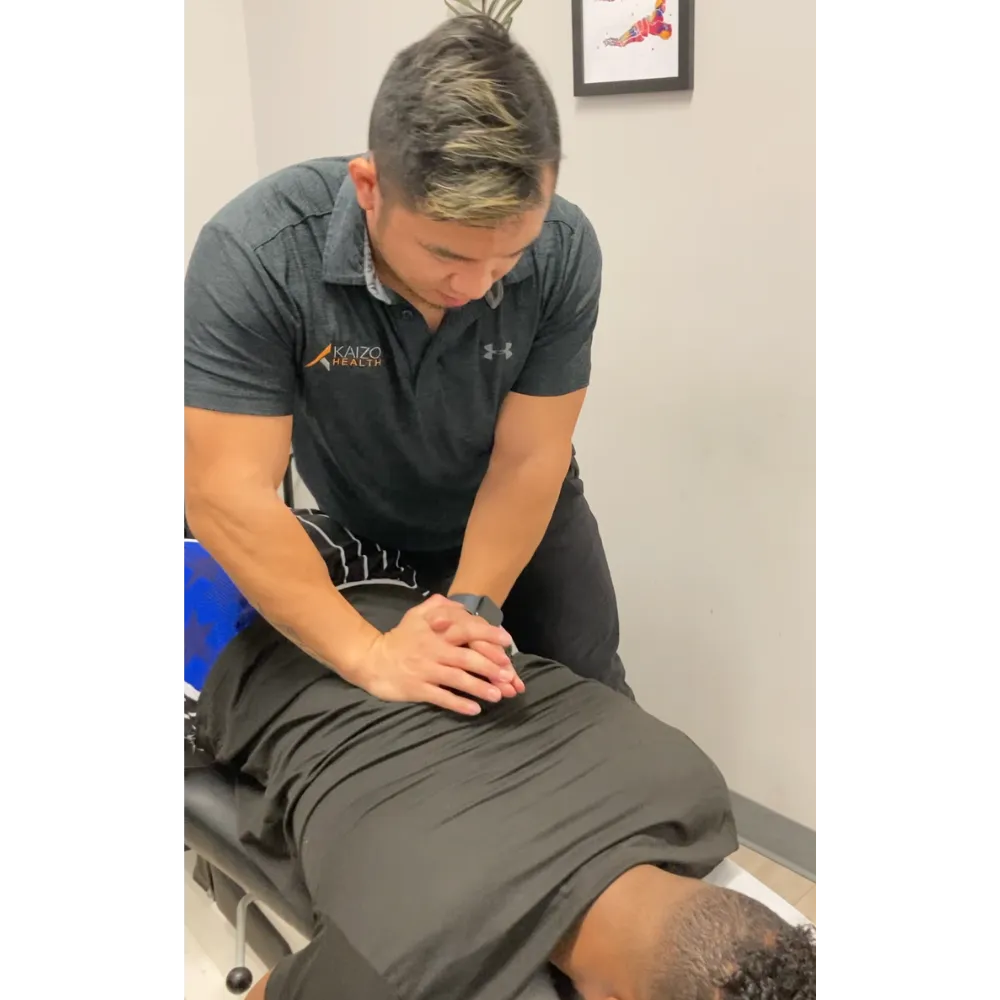 Dr. Stuckart performing a Chiropractic Adjustment for a patient at Kaizo Health