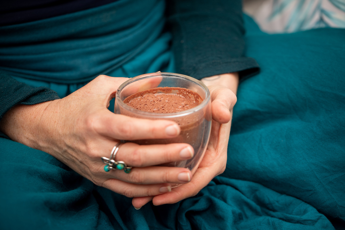 Ceremonial cacao setup with ceramic cup and flowers