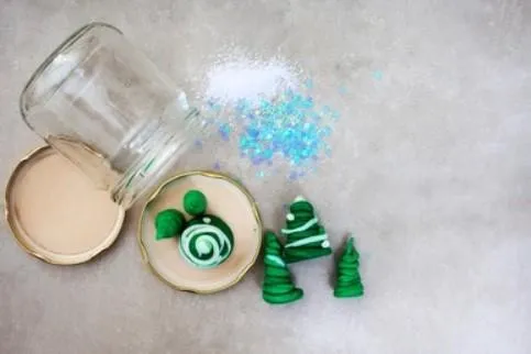 Boy picks paper out of different colored liquids