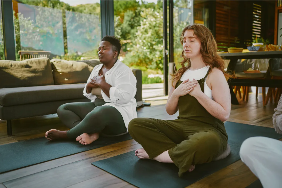 two women meditating feeling grounded