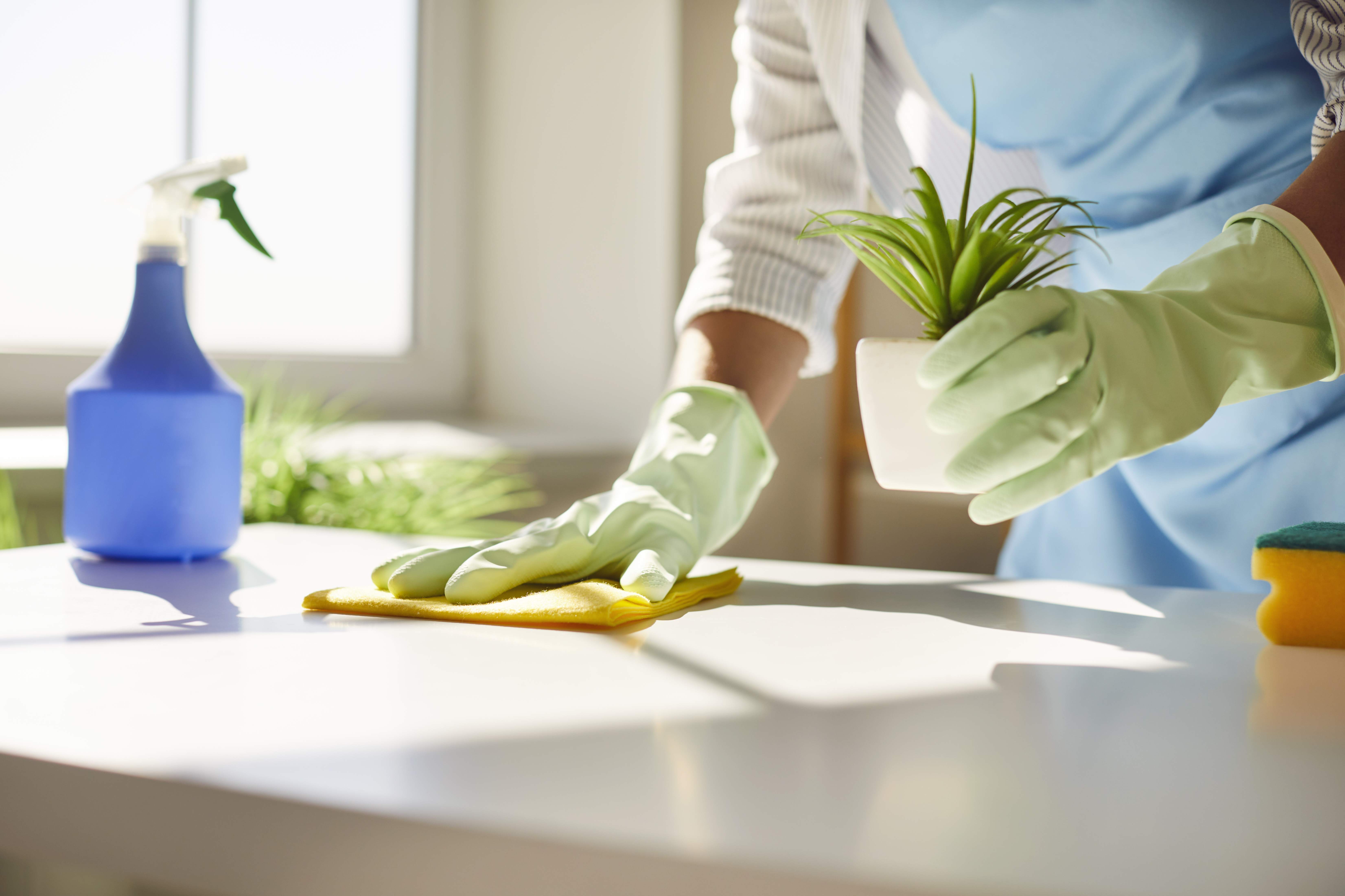 Man energetically vacuuming and dancing in a bright room.