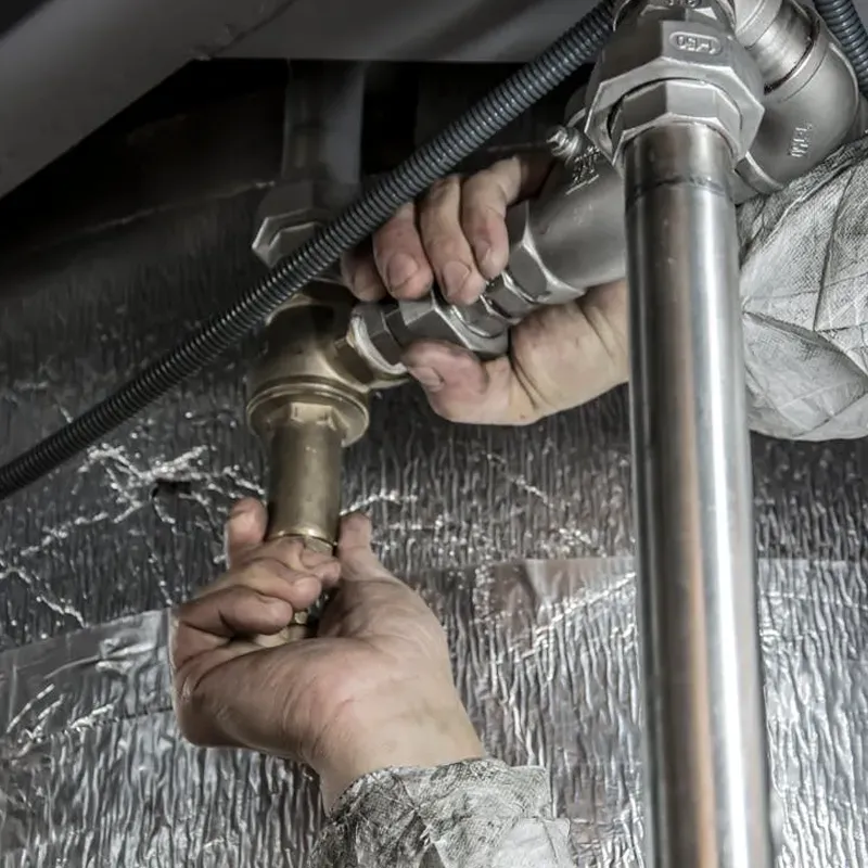 family posing and smiling for the camera infront of their home in the autumn