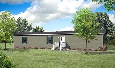 A single-story manufactured home with a front porch and steps set in a grassy area with trees and flower beds nearby under a partly cloudy sky.