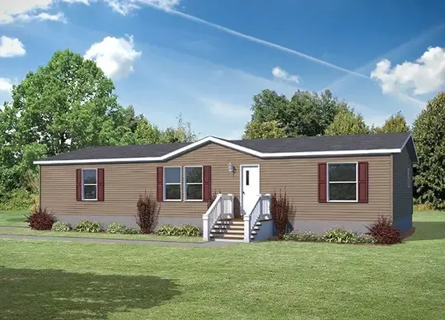 A single-story manufactured home by Houston Apex Modular Homes, featuring a brown exterior, white trim, and red shutters. It has a central entryway with stairs leading to a small porch and is surrounded by a grassy lawn and trees in the background.