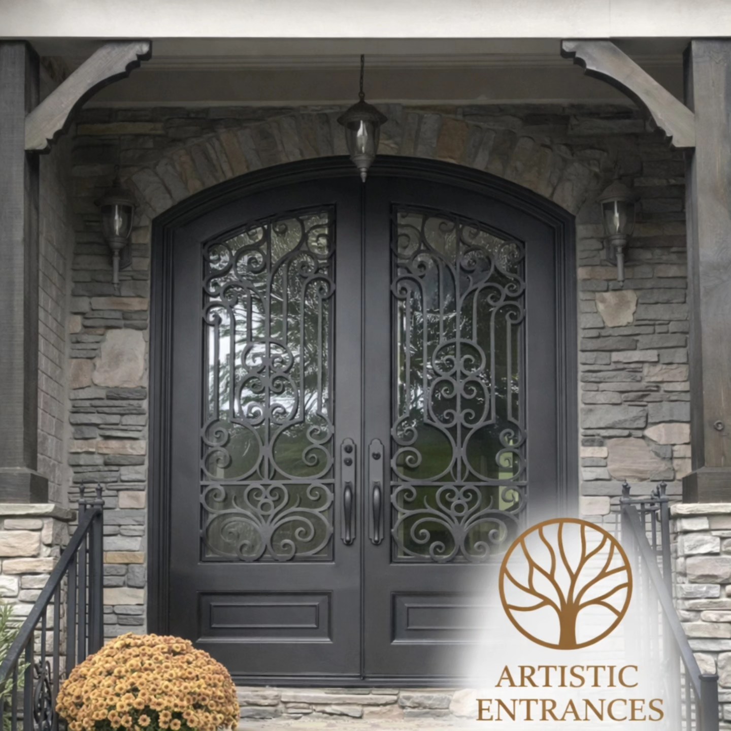 Luxury custom iron entry door with glass and warm stone exterior
