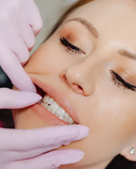 Close-up of a patient receiving a professional dental examination and assessment of their teeth.