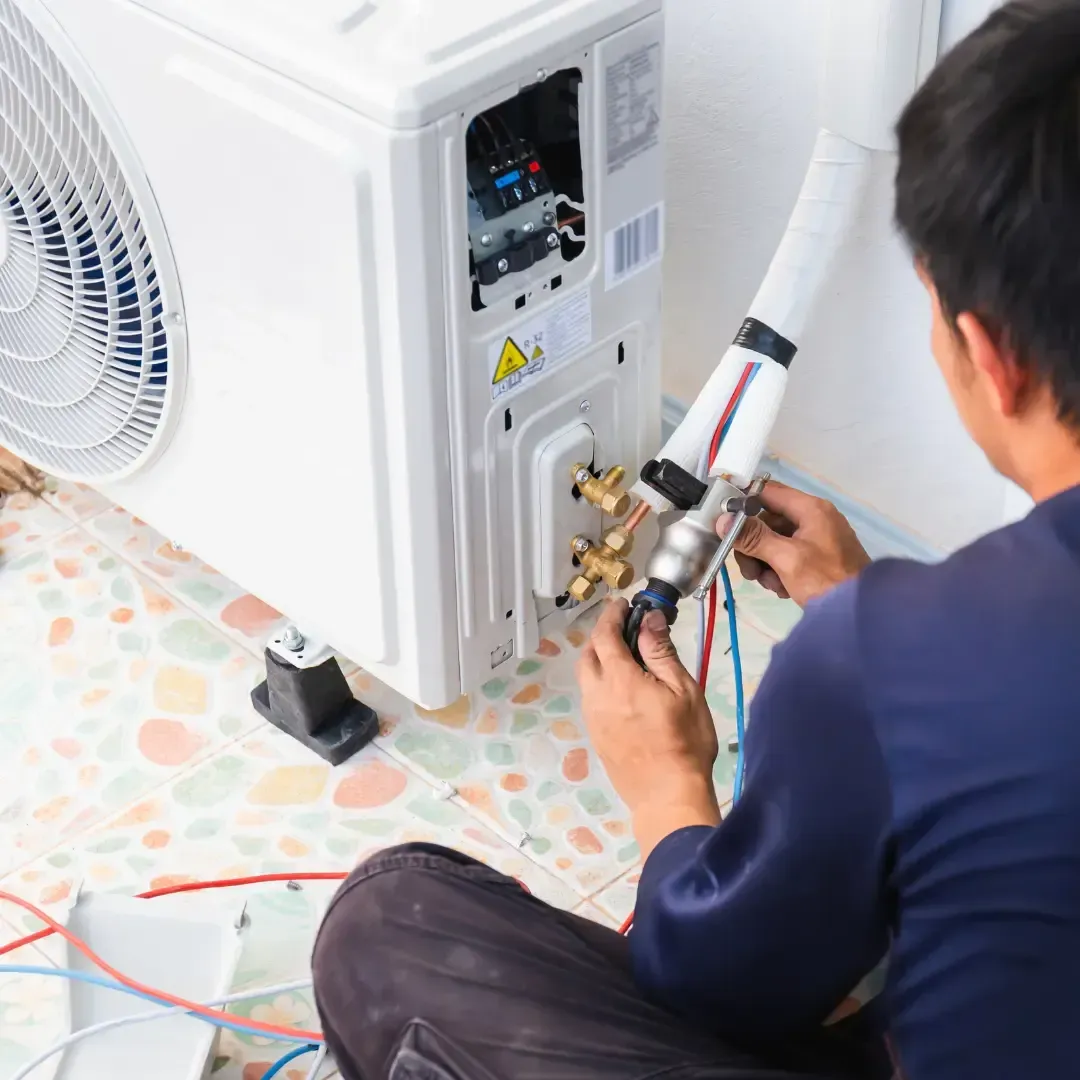Technician performing HVAC system maintenance and performance testing for residential home comfort services by MMI Home Manager