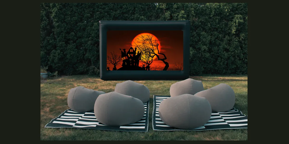 Halloween Movie Night: inflatable outdoor movie screen with bean bag seating on blankets