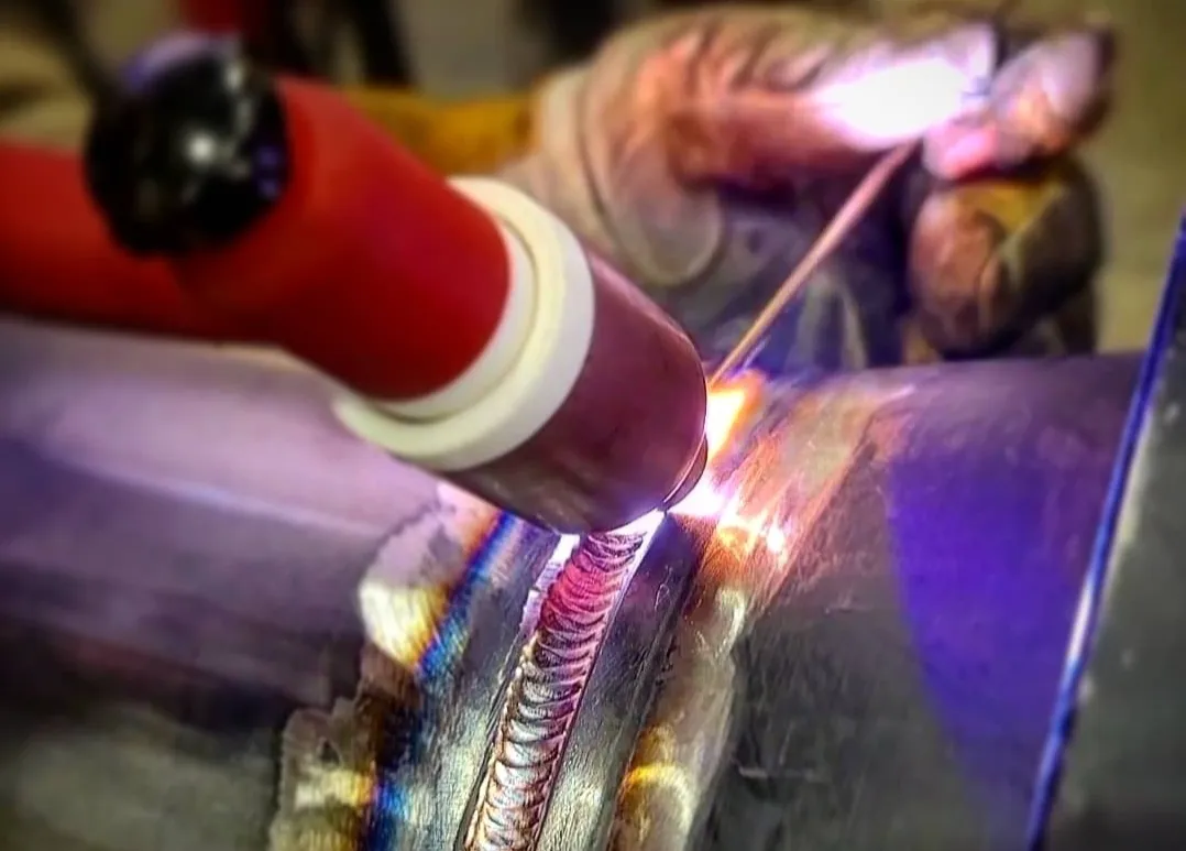 Welder observing molten weld pool to improve technique and bead quality
