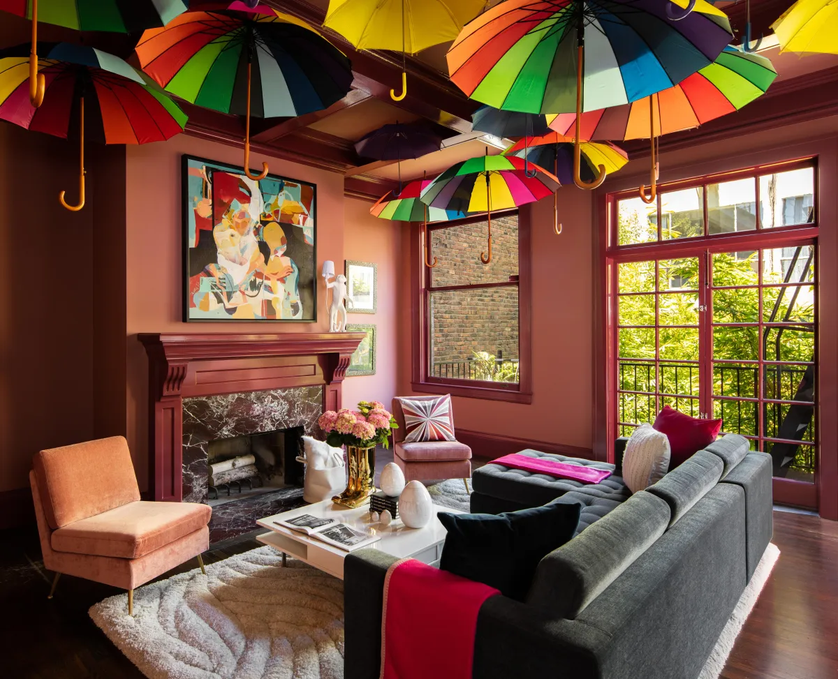 beautiful interior design library floor to ceiling shelves books lined up in rainbow colors old leather chairs brass light fixtures interior design photography by photographer thomas kuoh