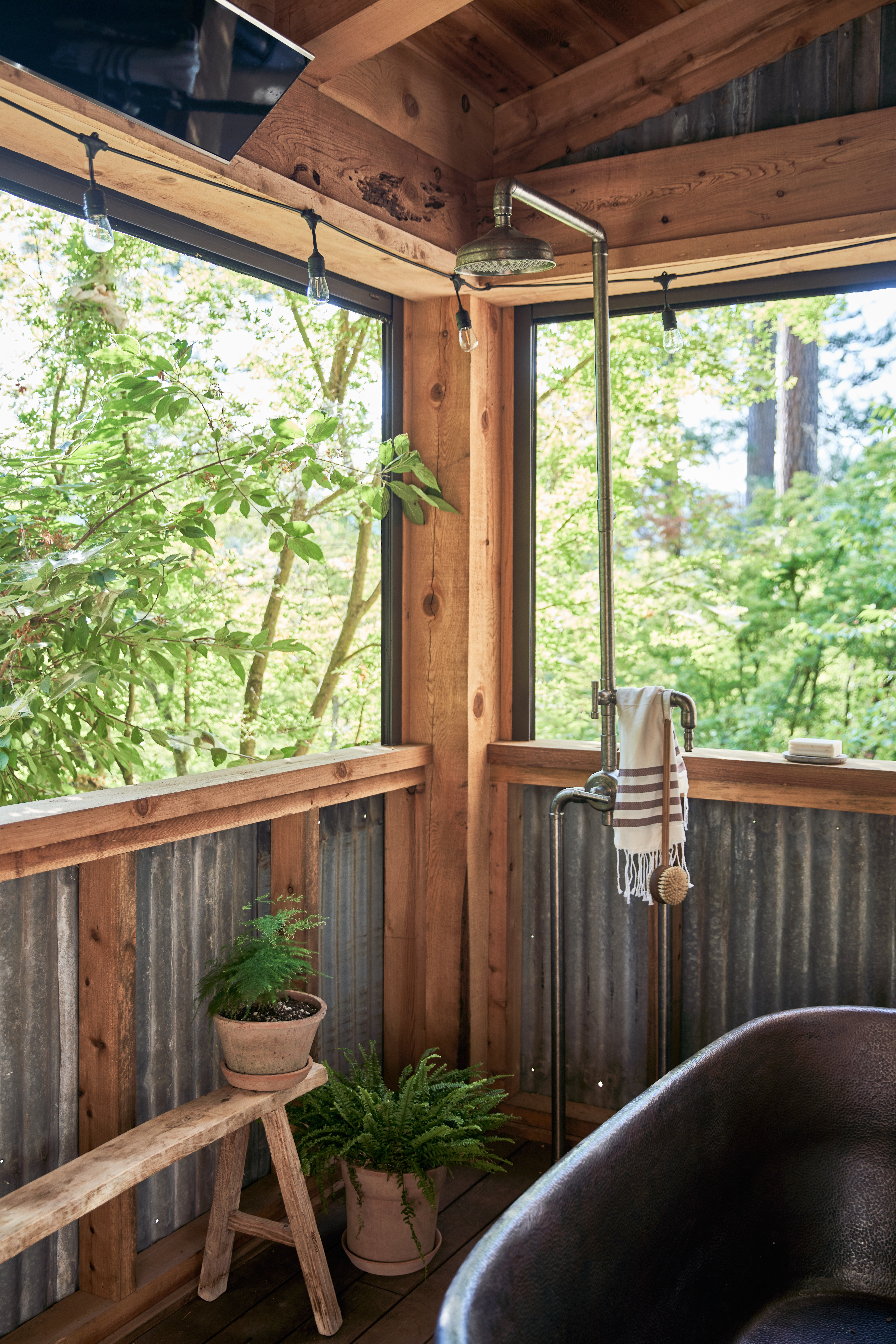 rustic shower outdoors with plants