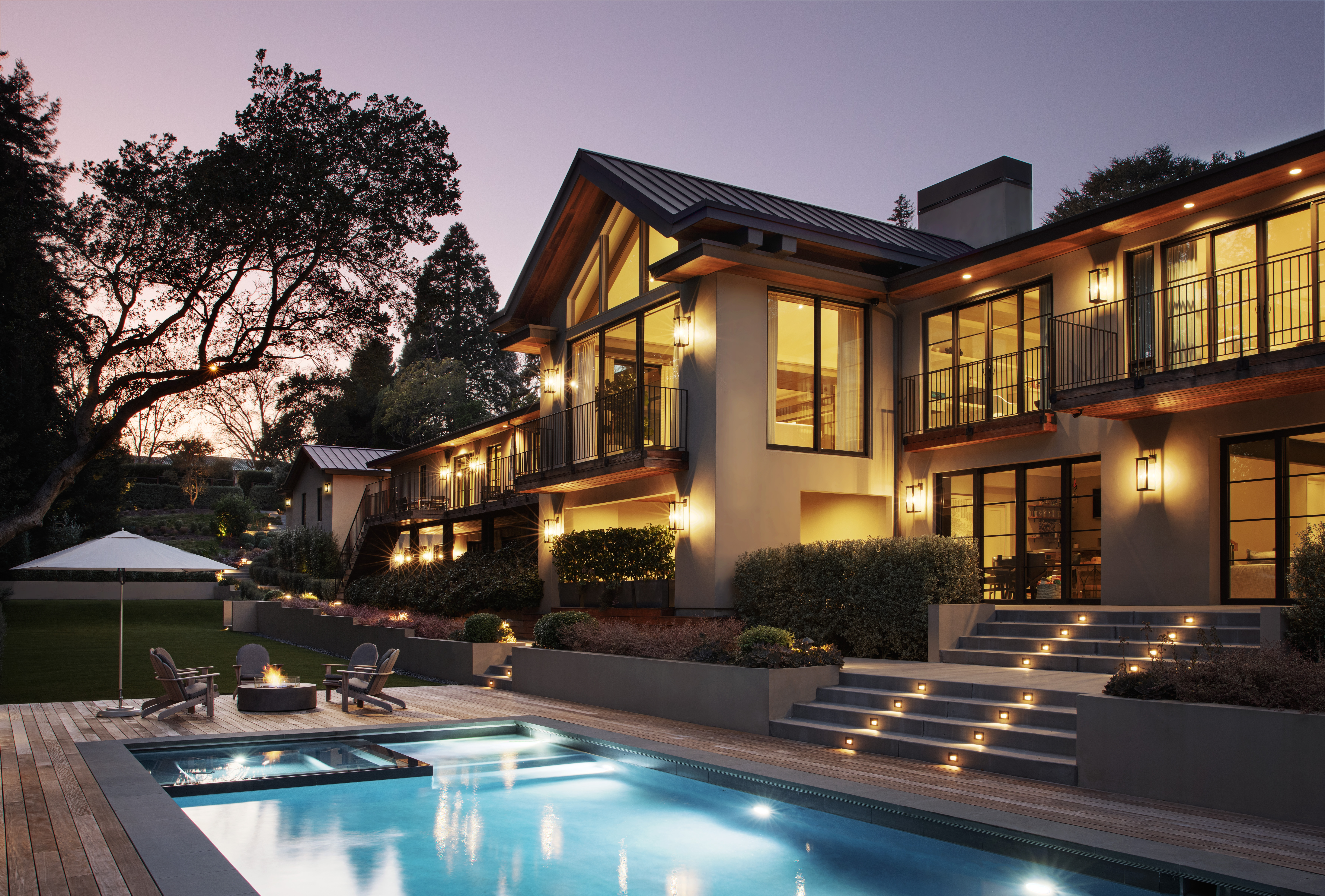night shot of architecture and pool with lighting and sunset