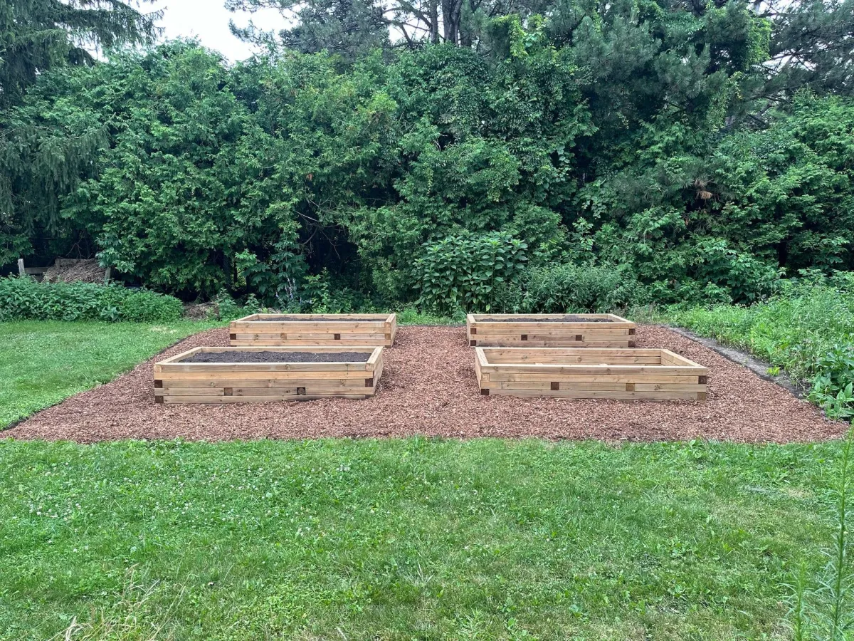 Garden bed design in Richmond Hill and Aurora — mixed perennials, shrubs, and clean edging at a residential property, daytime