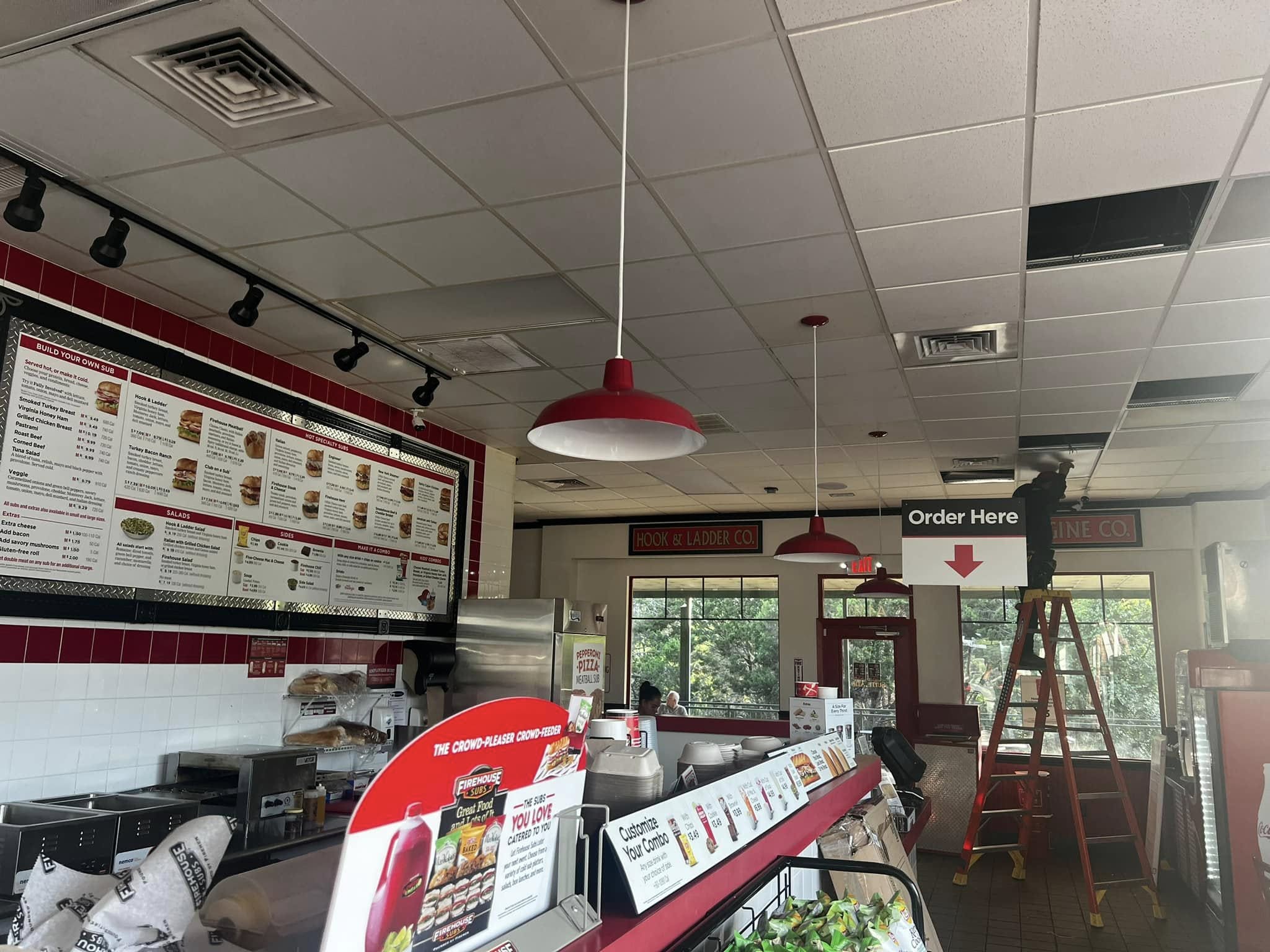Completed restaurant lighting installation with pendant and track lights, Austin TX