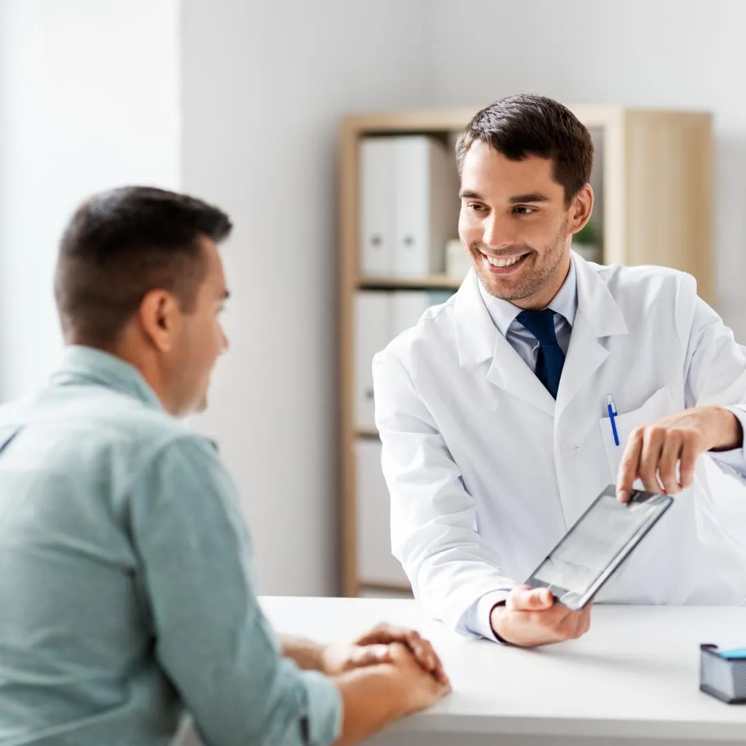 female doctor looking at a chart with her young female patient