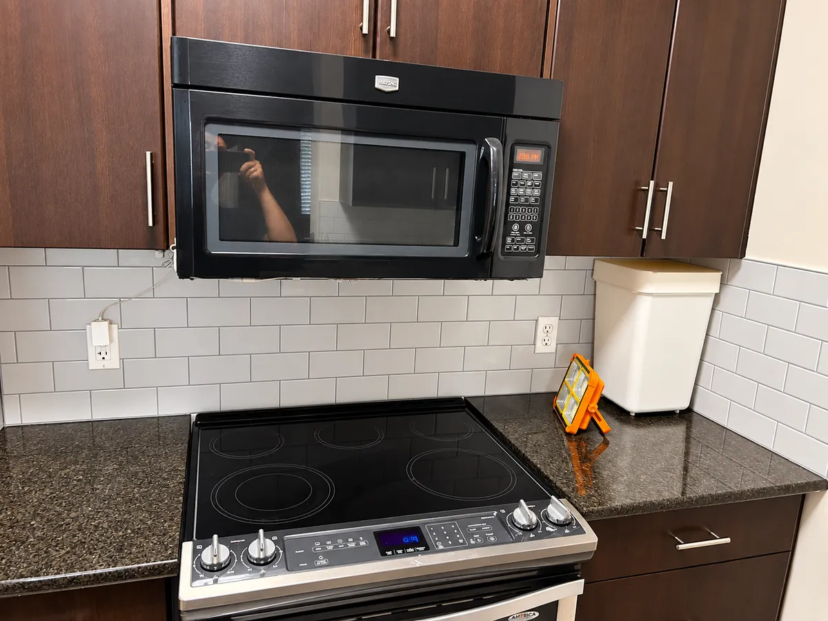 Kitchen backsplash tile installation with dark cabinets in Calgary