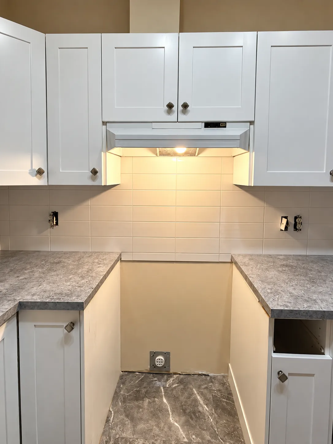 White subway tile backsplash installation in Calgary kitchen