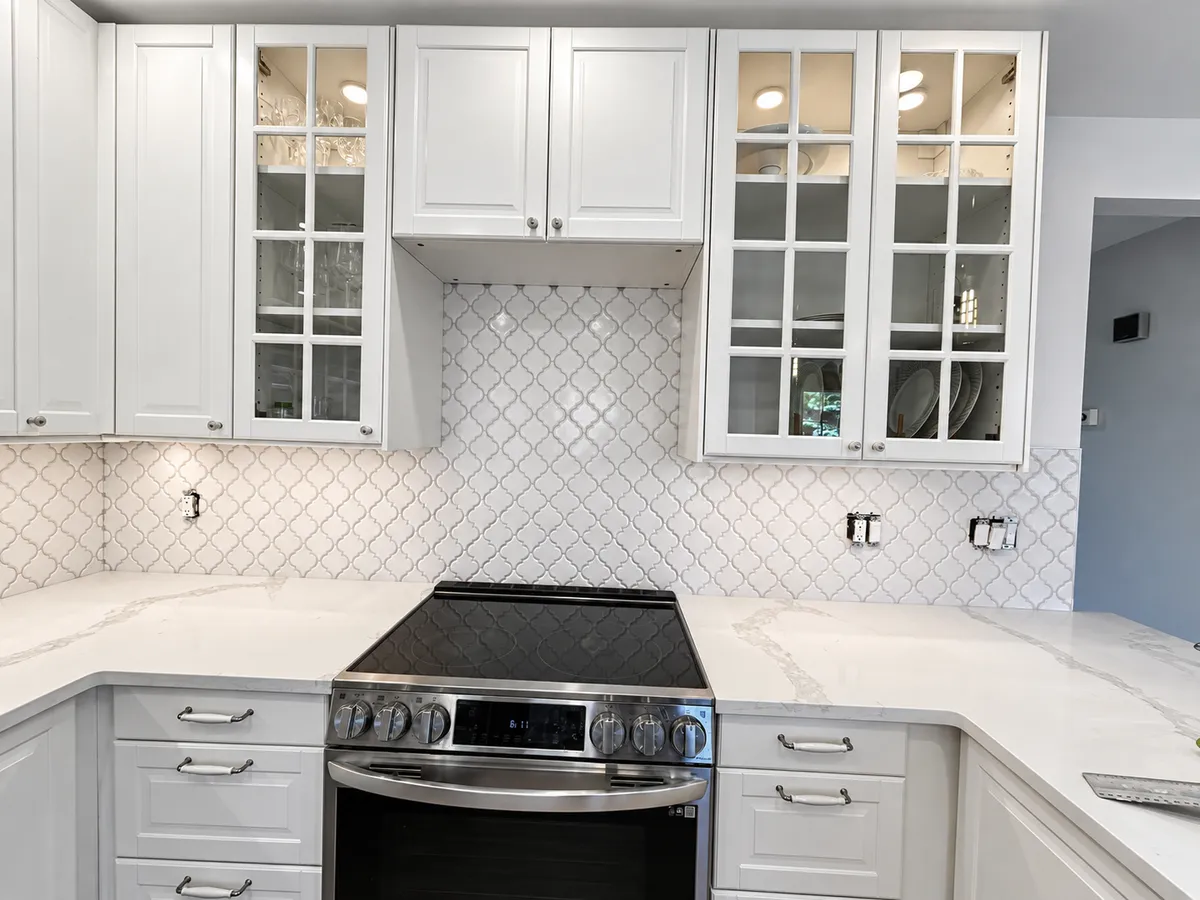 Kitchen renovation with white cabinets and tile backsplash in Calgary