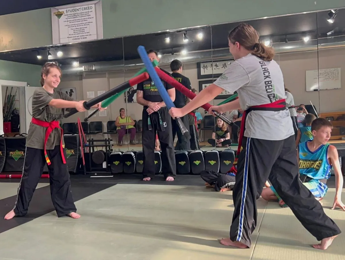 Kids martial arts class practicing together in uniform