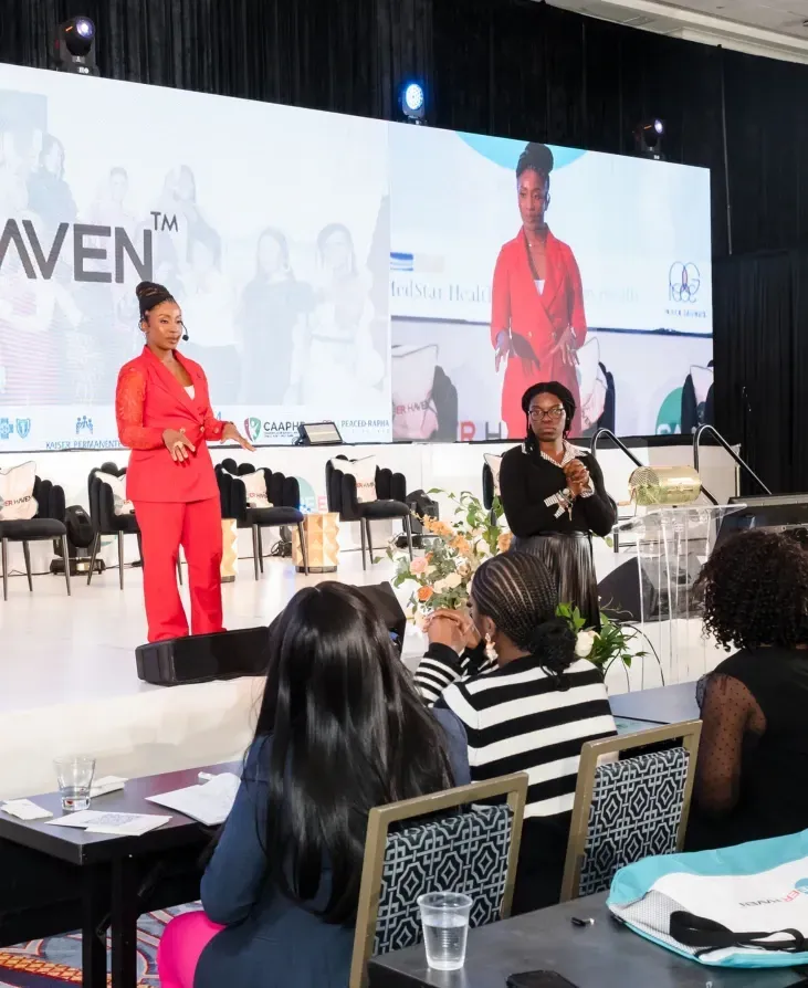 Dr. Ogo speaking on stage at a Career Haven event