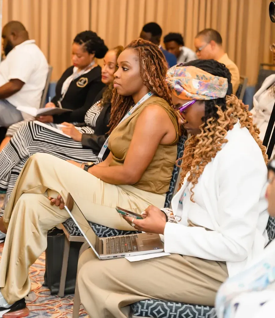 Health professionals taking notes in the audience at a Career Haven event