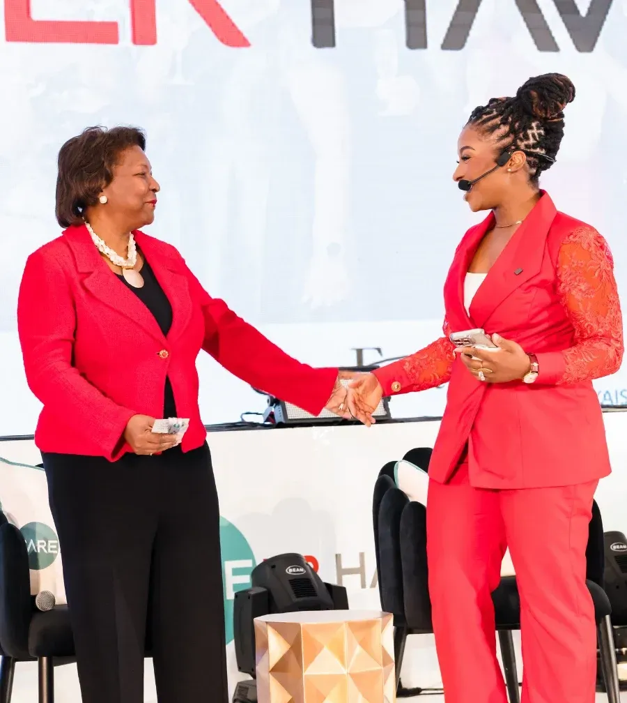 Dr. Ogo shaking hands with a healthcare professional on stage