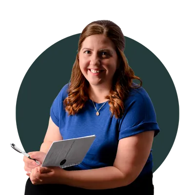 Cerys Thompson, smiling at the camera with a CT Communications notebook